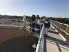 Visitors looking over water plant railing